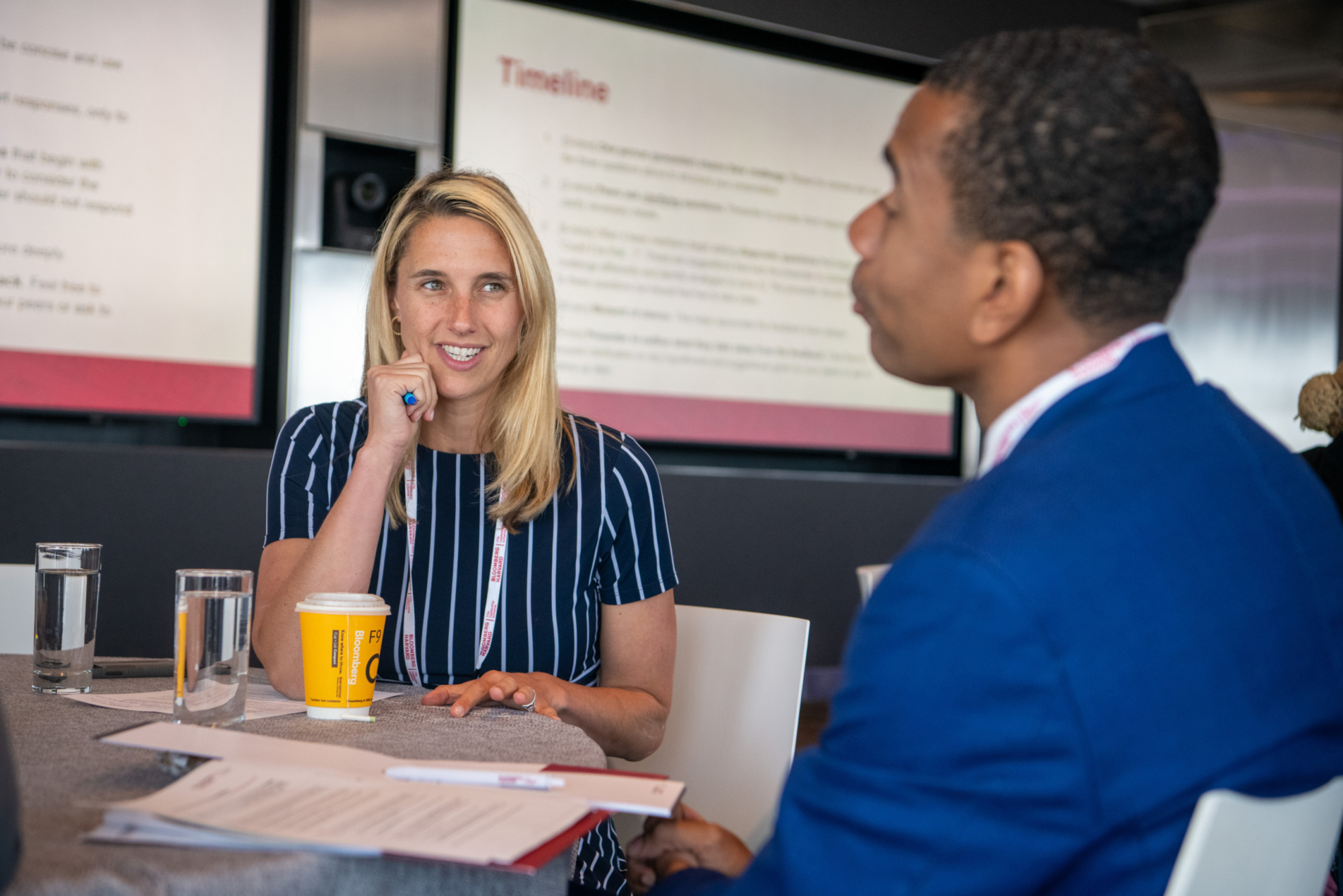 two people at a table talking